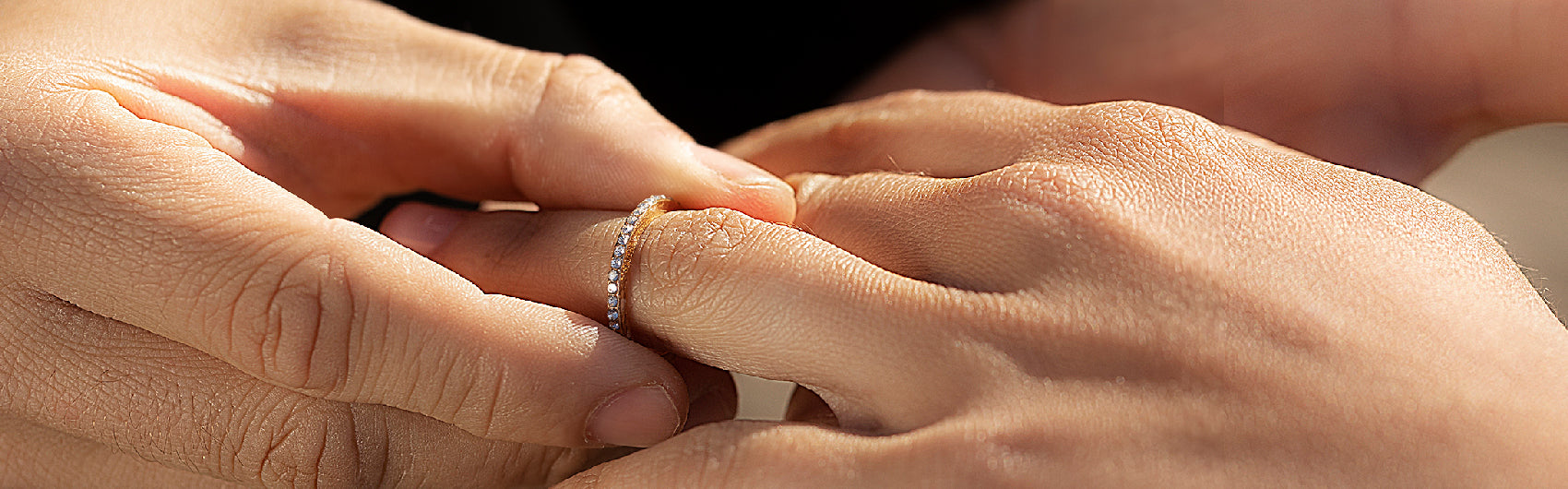 "Intertwined Hands Highlighting a Sparkling Diamond Ring - A Symbol of Eternal Love"